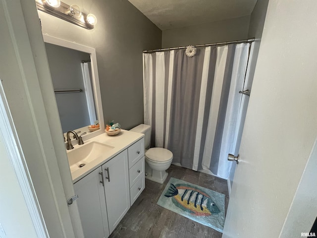 bathroom with vanity, toilet, curtained shower, and wood-type flooring