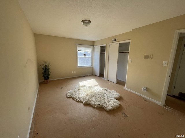 unfurnished bedroom featuring two closets