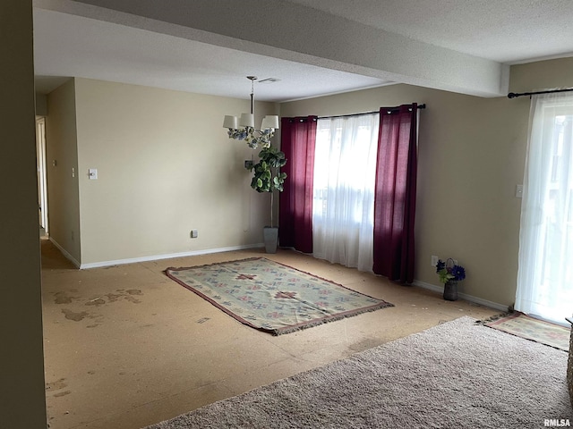 unfurnished room with a textured ceiling