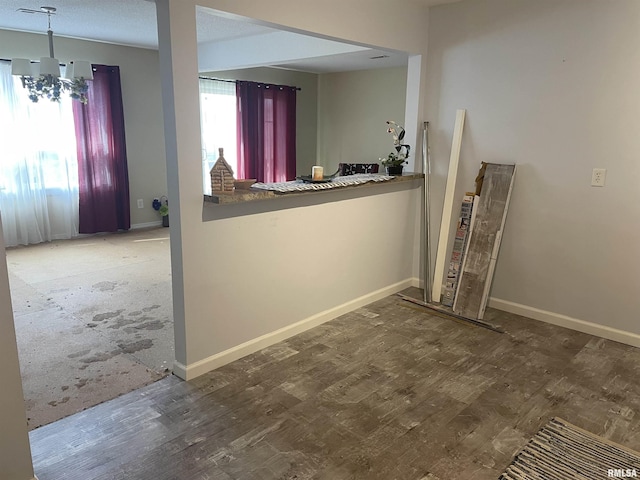 interior space featuring an inviting chandelier, plenty of natural light, and hardwood / wood-style floors