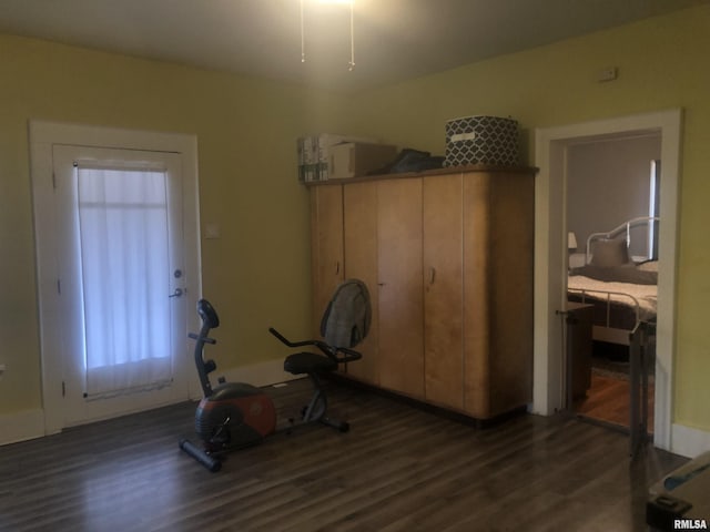 workout area with dark hardwood / wood-style flooring