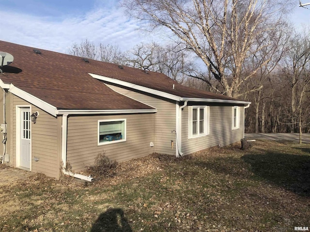 rear view of property featuring a lawn