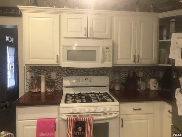 kitchen featuring backsplash, white cabinets, and white appliances