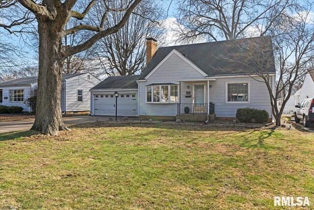 view of front of house with a garage and a front yard