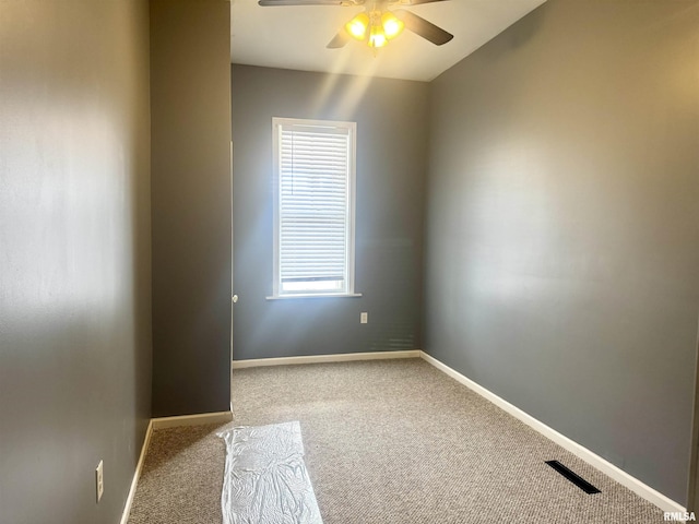 empty room with ceiling fan and light carpet