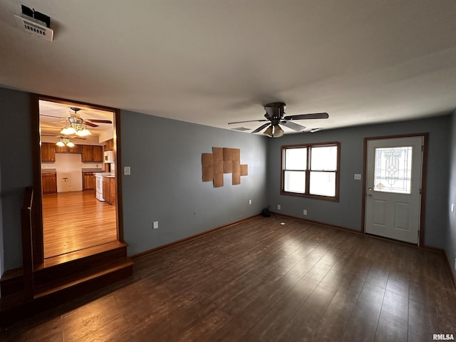 unfurnished living room with hardwood / wood-style flooring and ceiling fan