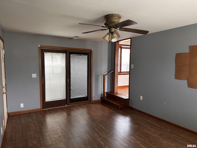 spare room with ceiling fan and dark hardwood / wood-style flooring