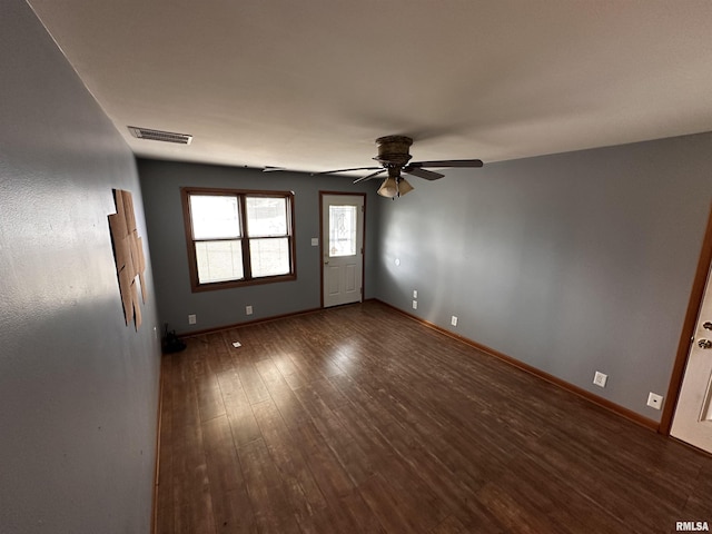 empty room featuring dark hardwood / wood-style floors and ceiling fan