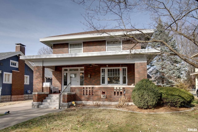 view of front of home featuring covered porch and a front yard