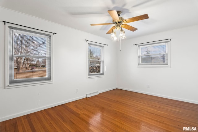 empty room with hardwood / wood-style flooring and ceiling fan