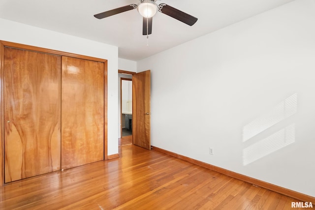 unfurnished bedroom with ceiling fan, hardwood / wood-style floors, and a closet