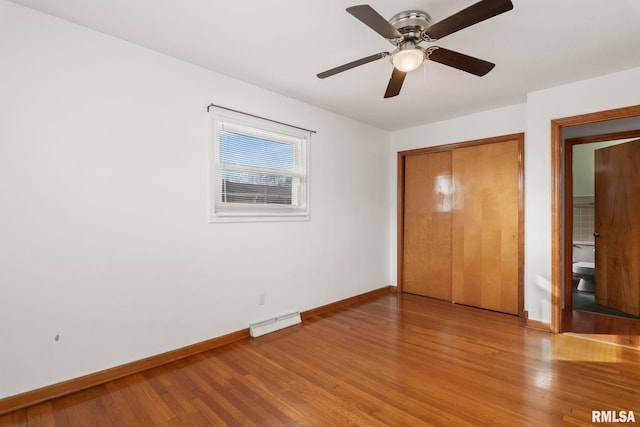 unfurnished bedroom featuring hardwood / wood-style flooring, ceiling fan, and a closet