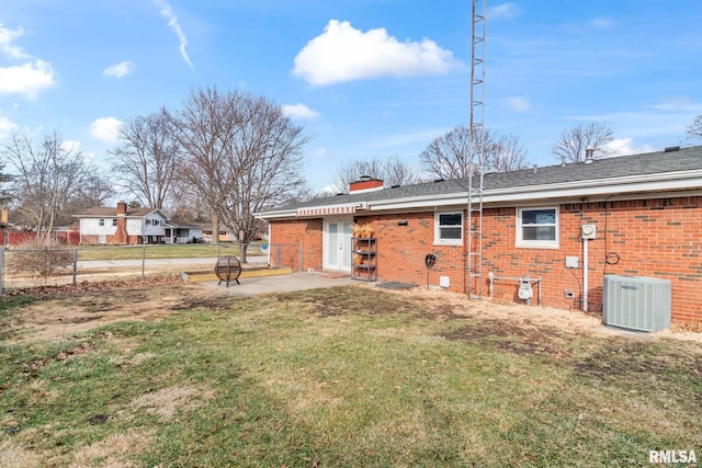 rear view of house with a lawn, a patio, and central air condition unit