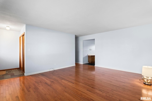 spare room featuring dark hardwood / wood-style flooring