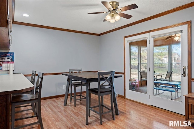 dining area with crown molding, light hardwood / wood-style floors, and ceiling fan