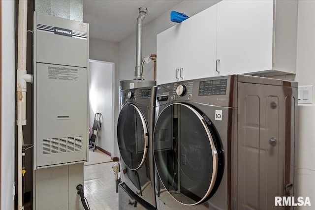 laundry area featuring independent washer and dryer and cabinets