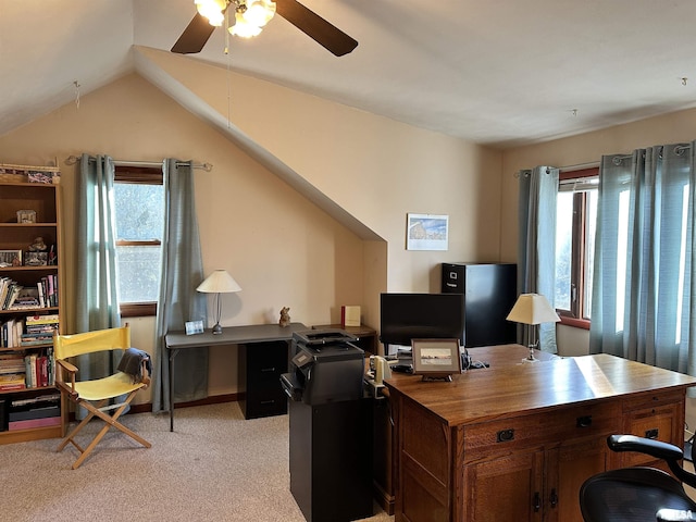 home office with ceiling fan, light colored carpet, a healthy amount of sunlight, and vaulted ceiling