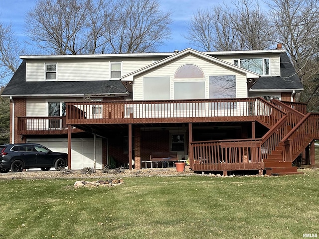 back of property with a garage, a lawn, and a deck