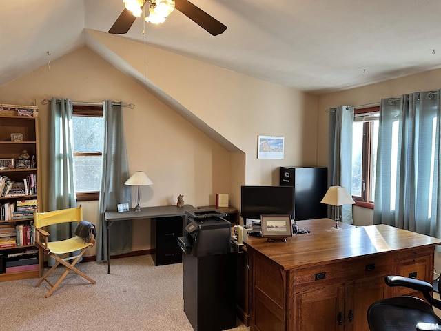 office area featuring lofted ceiling, a wealth of natural light, light carpet, and ceiling fan