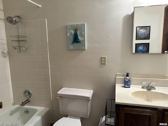 full bathroom with tiled shower / bath, vanity, and toilet