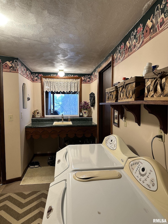 laundry area featuring carpet, a sink, independent washer and dryer, and a textured ceiling