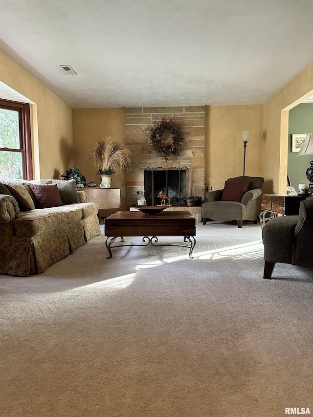 living room featuring light colored carpet and a fireplace