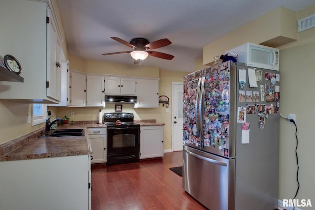 kitchen featuring stainless steel refrigerator, sink, white cabinets, dark hardwood / wood-style flooring, and black / electric stove