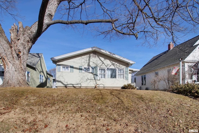 back of property featuring a yard