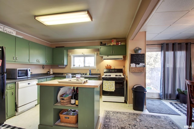 kitchen featuring a kitchen island, green cabinets, wooden counters, and white appliances