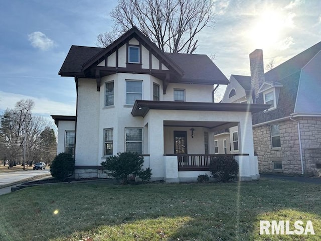 2340 Maine St, Quincy, IL 62301 - view of front facade with a porch, stucco siding, and a front lawn