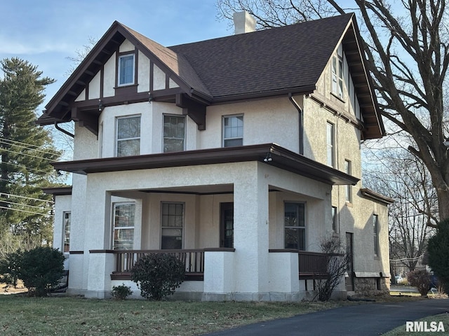 2340 Maine St, Quincy, IL 62301 - view of front of house with stucco siding, covered porch, and a shingled roof