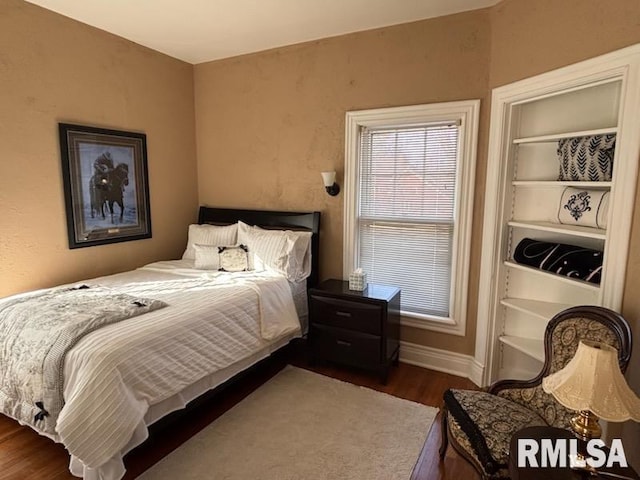 bedroom featuring dark hardwood / wood-style flooring