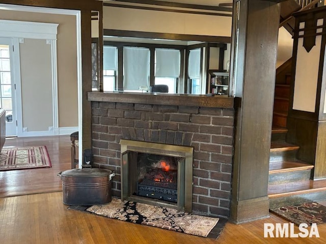 2340 Maine St, Quincy, IL 62301 - detailed view of wood finished floors, a brick fireplace, and baseboards