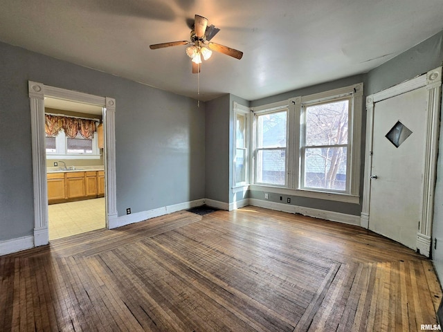 spare room featuring ceiling fan, sink, and light hardwood / wood-style flooring