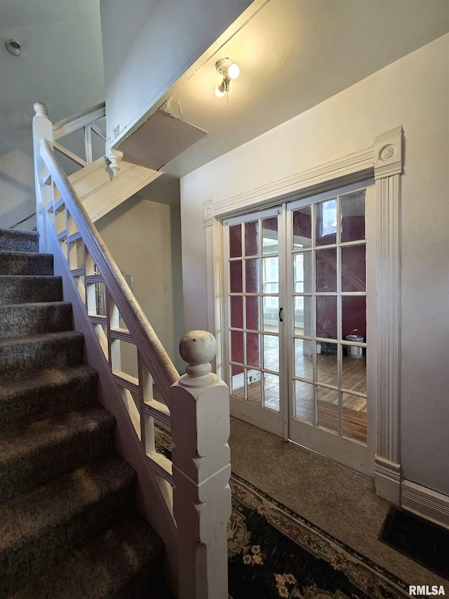 staircase with carpet flooring and french doors