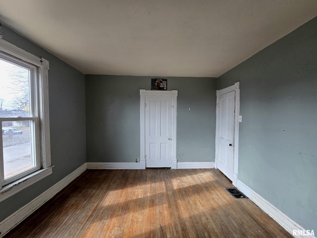 empty room featuring wood-type flooring