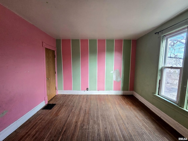 empty room with hardwood / wood-style floors