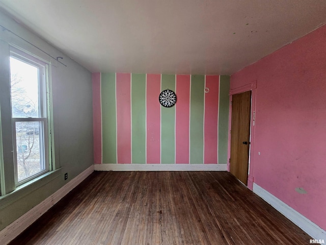 unfurnished room with hardwood / wood-style flooring