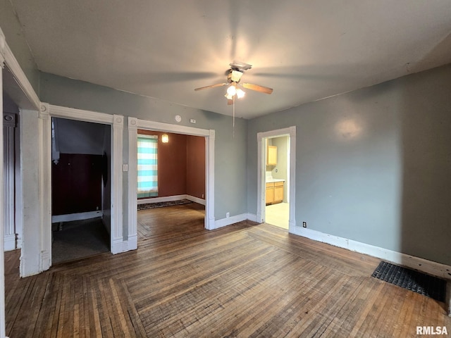 empty room with hardwood / wood-style floors and ceiling fan