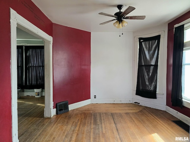 spare room with hardwood / wood-style flooring and ceiling fan