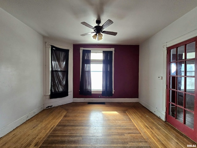 unfurnished room with hardwood / wood-style floors and ceiling fan