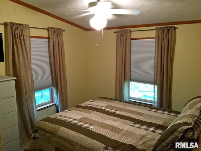 bedroom with ornamental molding, lofted ceiling, and ceiling fan