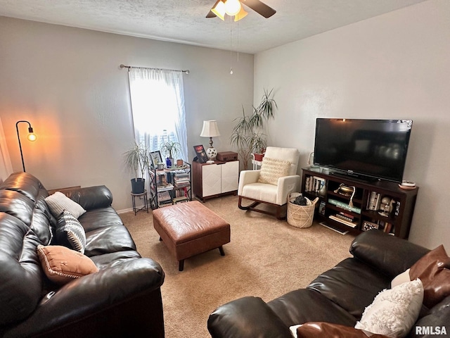 carpeted living room featuring ceiling fan and a textured ceiling