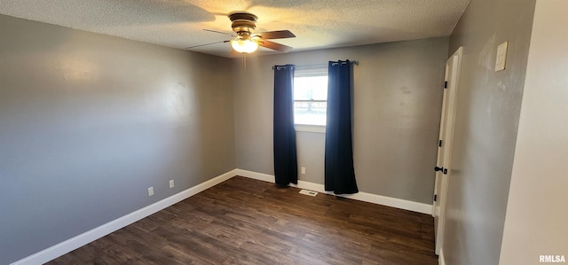 unfurnished room with ceiling fan, a textured ceiling, and dark hardwood / wood-style flooring