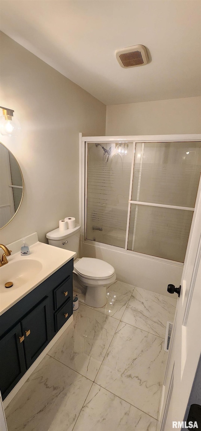 full bathroom featuring vanity, toilet, and combined bath / shower with glass door