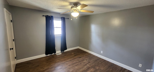 empty room featuring ceiling fan, dark hardwood / wood-style floors, and a textured ceiling