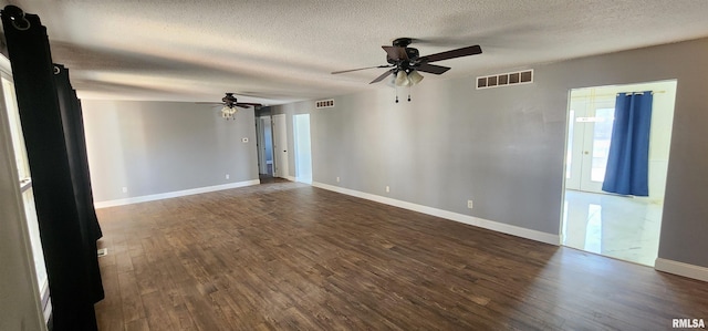 unfurnished room featuring ceiling fan, a textured ceiling, and dark hardwood / wood-style flooring