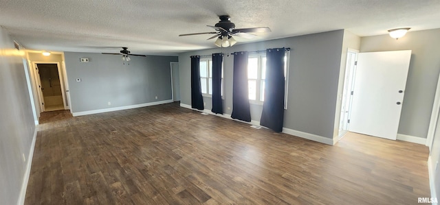 spare room featuring ceiling fan, dark hardwood / wood-style floors, and a textured ceiling