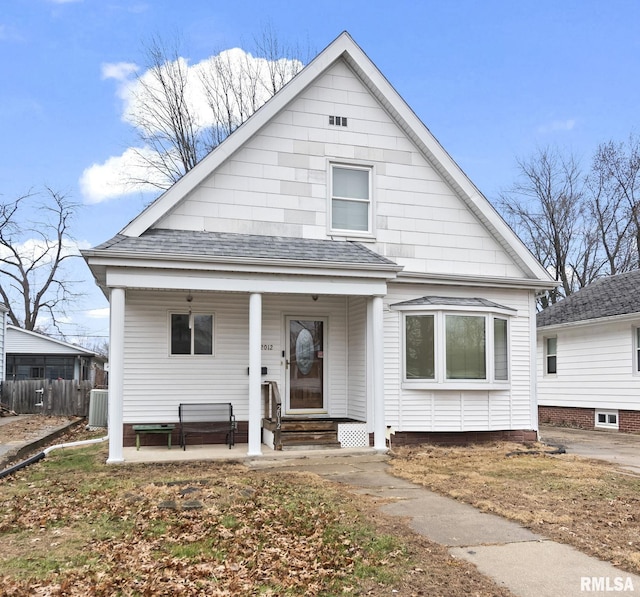 bungalow-style house featuring a porch and cooling unit