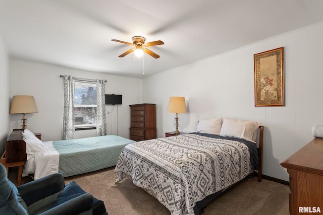 carpeted bedroom featuring crown molding and ceiling fan